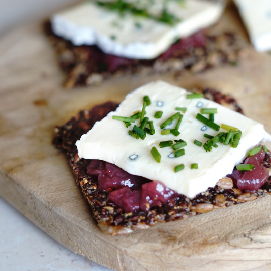 Crackers with whipped ricotta and blue berries jam